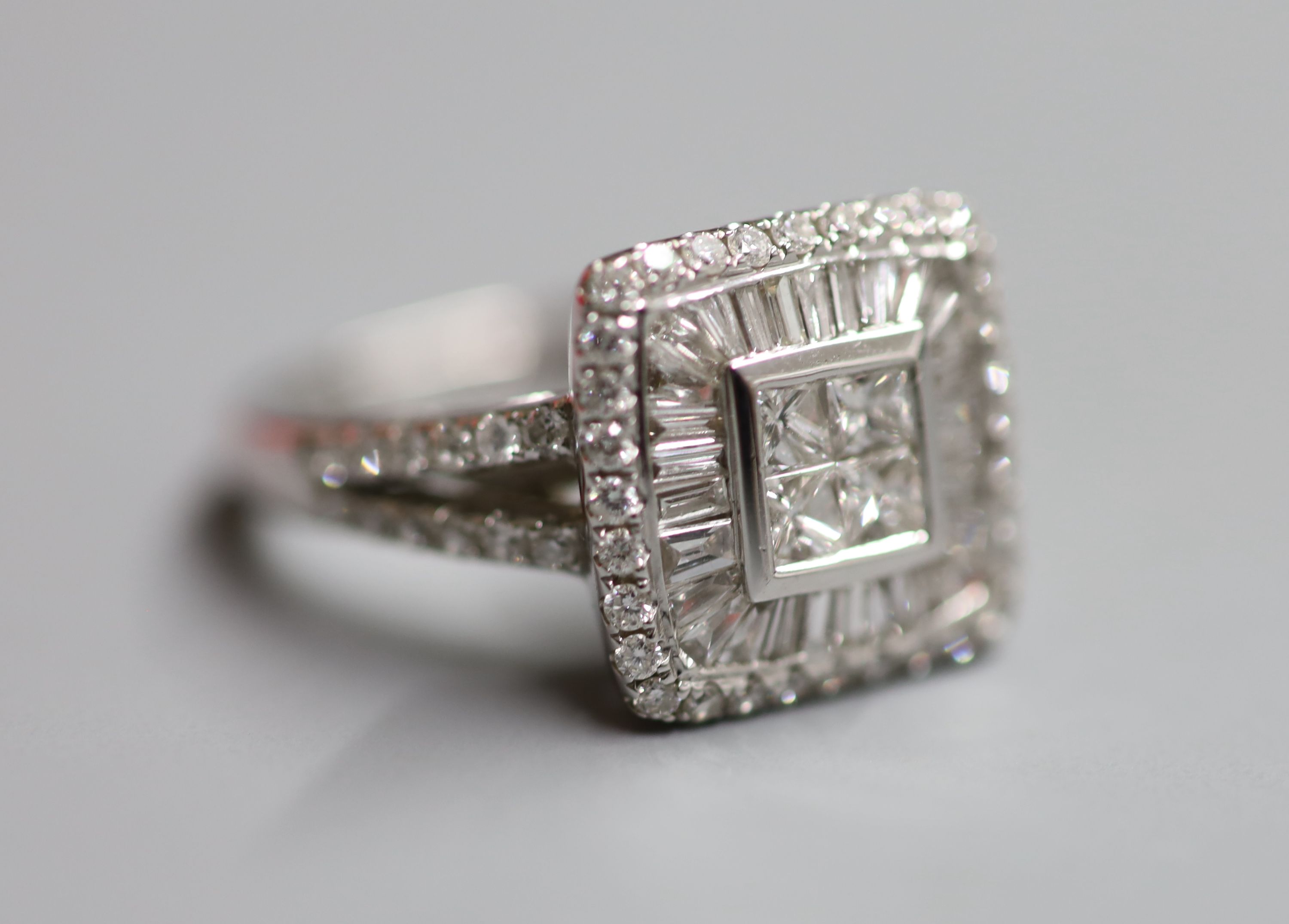 A modern 18ct white gold and diamond square cluster ring, with twin row diamond set shoulders, size Q, gross 6.8 grams,